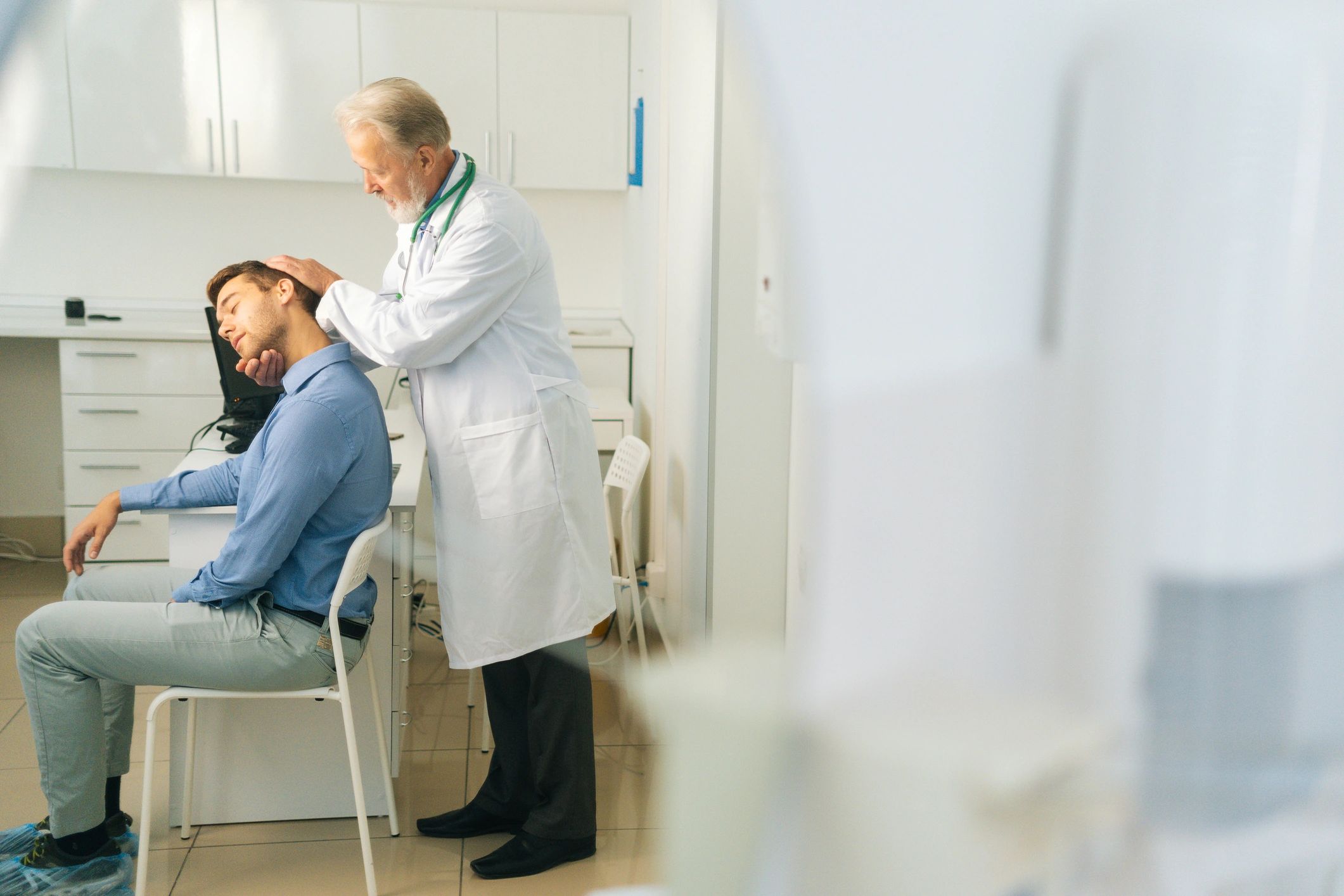Chiropractor evaluating a patient in a clinical setting